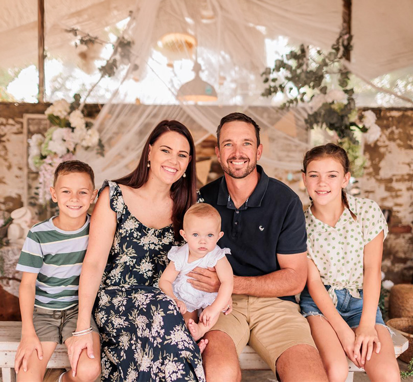 Jurgens "Yogi" Potgieter and his family—wife and three children—seated together under a decorated canopy.
